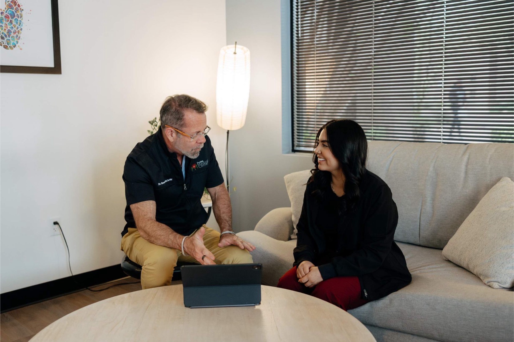 A Protea physician talking with a patient in a consultation room